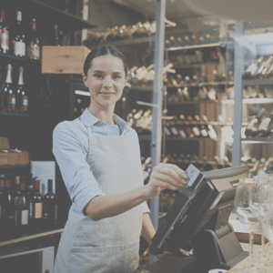 merchant swiping credit card at wine store